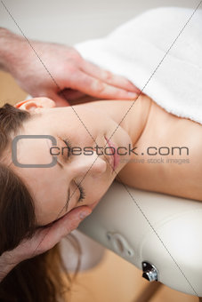Neck of a patient being massaged by a chiropractor