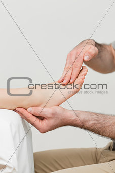 Practitioner holding the foot of a patient