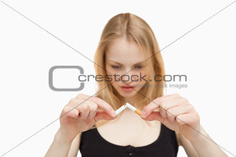 Fair-haired woman braking a cigarette