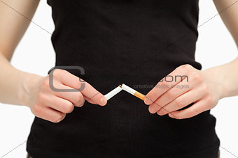 Close up of hands breaking a cigarette