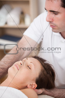Serious doctor manipulating his patient