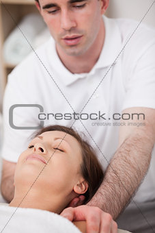 Physiotherapist manipulating the neck of his patient