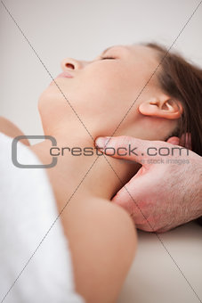 Close-up of doctor pressing his thumb on the neck of his patient