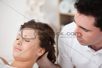 A doctor massaging the head of his patient while holding it