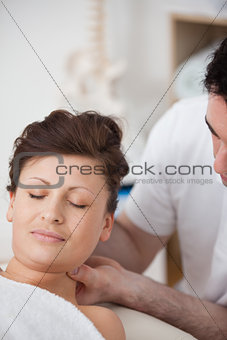 Woman being massaging her head while raising it