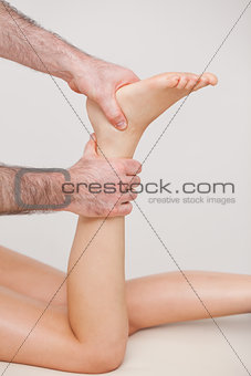 Podiatrist manipulating the ankle of his patient