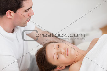 Masseur massaging the neck of his patient 