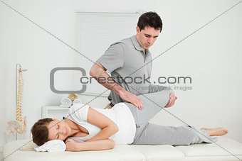 Leg of a woman being manipulated by a chiropractor