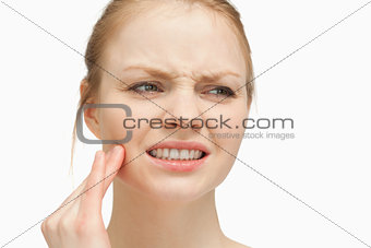 Woman massaging her cheek