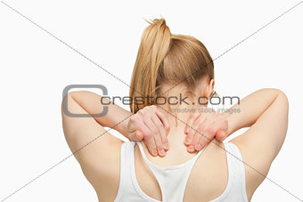 Woman massaging her nape with her hands