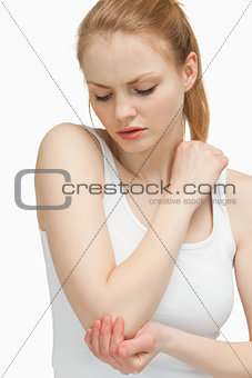Woman touching her elbow