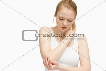 Young woman touching her elbow
