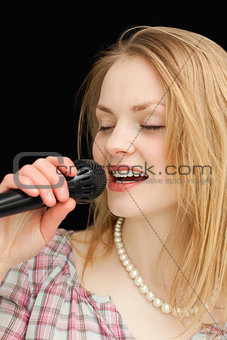 Woman singing while closing her eyes