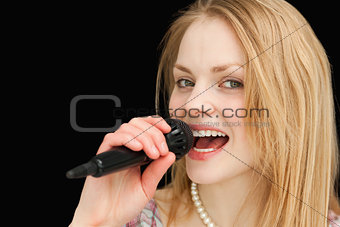 Young blond-haired woman singing