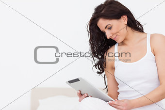 Brunette woman watching her tablet computer