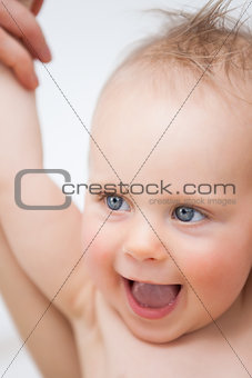 Cute baby laughing while opening her mouth