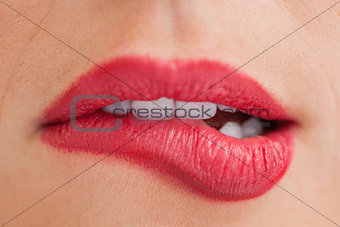 Attractive woman biting her beautiful lips