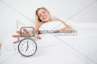 Blonde getting her alarm clock
