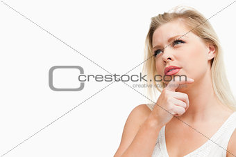 Attractive blonde woman lost in thoughts