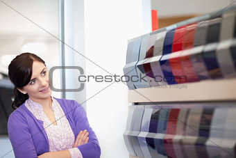 Woman crossing arms while looking at a color palette
