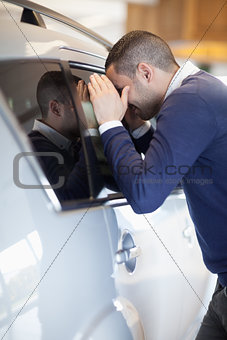 Customer looking inside a car