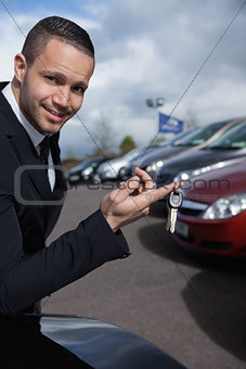 Man holding car keys with a finger