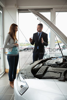 Businessman presenting a car to a woman