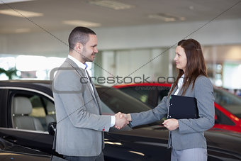 Businesswoman shaking hand of a man