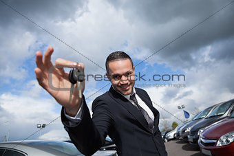 Happy seller holding car keys 