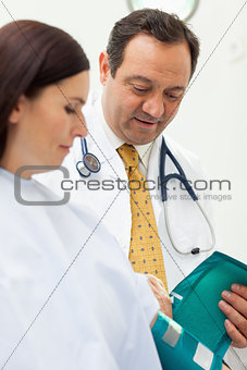Doctor placing a sphygmomanometer around the arm of his patient