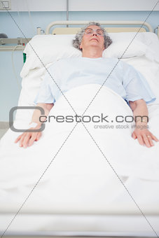 Elderly patient lying on a bed