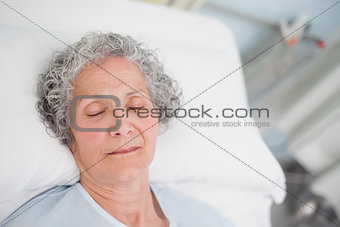 Elderly patient sleeping on a bed