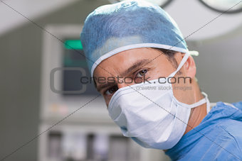 Earnest doctor looking at camera