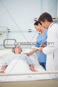 Doctor and nurse speaking to a patient