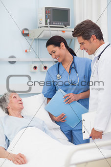 Elderly patient talking to a doctor and a nurse