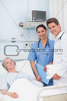 Patient with her doctor and nurse looking at camera
