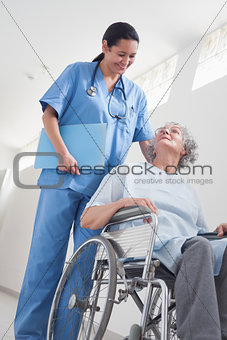 Elderly patient in a wheelchair next to a nurse