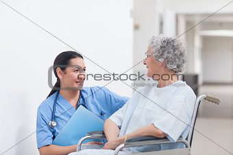 Nurse next to a patient in a wheelchair