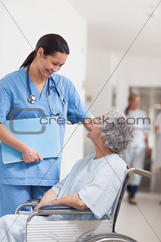 Nurse standing next to a patient in a wheelchair