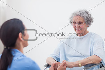 Nurse holding hands of a patient