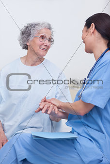 Nurse and a patient sitting on a bed