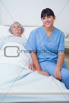 Nurse sitting on a medical bed