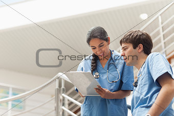 Nurse holding a clipboard while looking it 