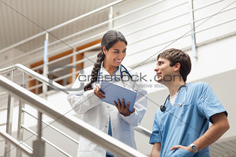 Female doctor holding a tablet computer on stairs