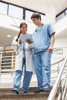 Doctor and nurse in the stairs