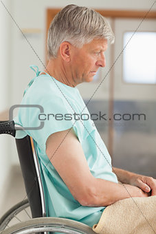 Sad man sitting in a wheelchair