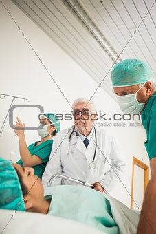 Doctor and surgeon looking at a female patient