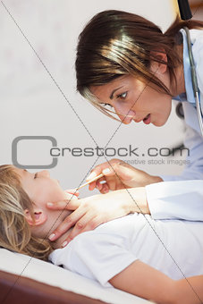Serious doctor examining a child