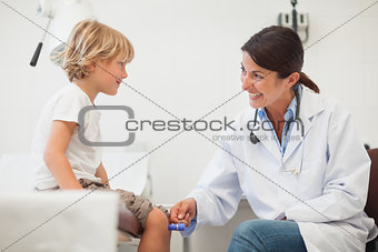 Female doctor auscultating a child