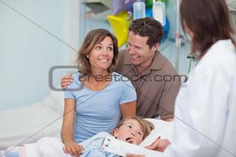 Smiling parents next to a doctor